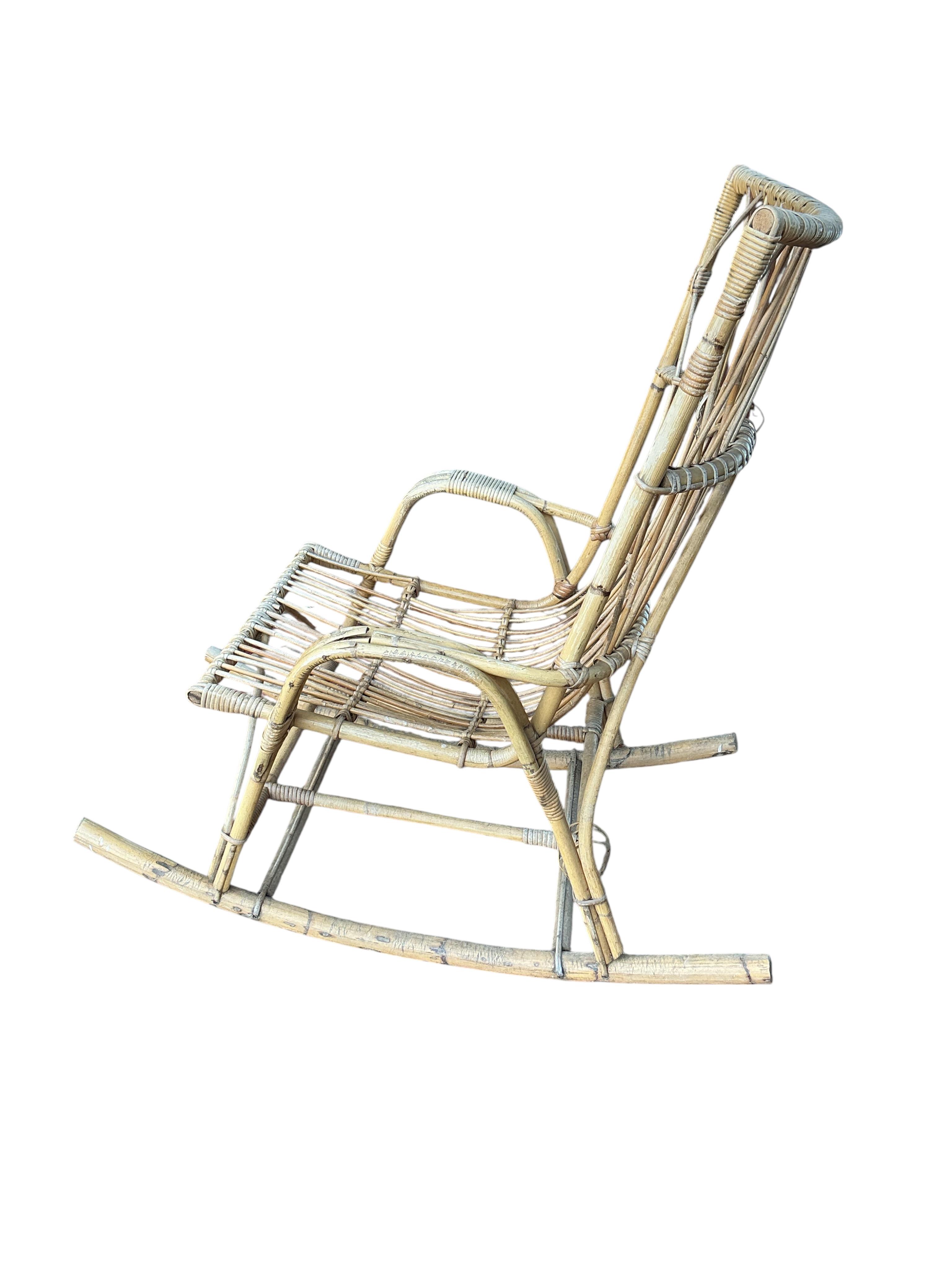 A vintage caned bamboo rocking chair, width 62cm, depth 101cm, height 106cm